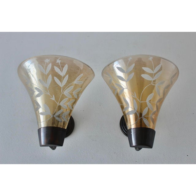 Vintage wall sconces in the style of Finnish designer Mauri Almari for Idman, featuring blown champagne glass shades with...