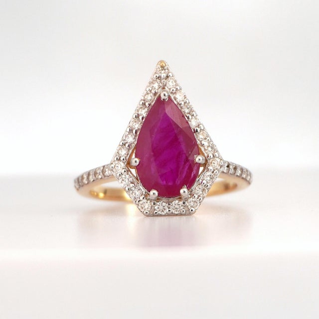 Discover the allure of modern elegance with our exquisite Ruby and Diamond Ring. This captivating piece, set in 18K yellow...