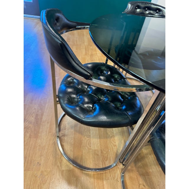 Black Glass table with matching 4 chairs in black leather.