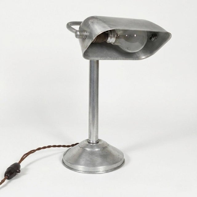 Bring a touch of mid-century industrial aesthetics to your workspace with this authentic 1940s-50s desk lamp. Crafted with...