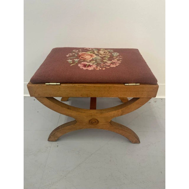 This Footstool has a beautiful ‘X’ frame base with sculpted wood detailing. The seat flips up and offer storage. Vintage...