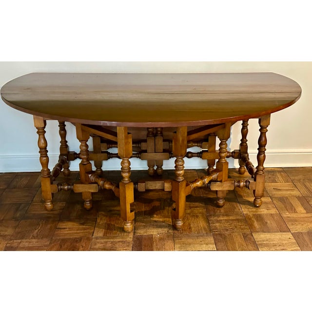A beautiful vintage solid cherry double gate leg drop-leaf table by Stickley Furniture, expertly crafted in the classic...
