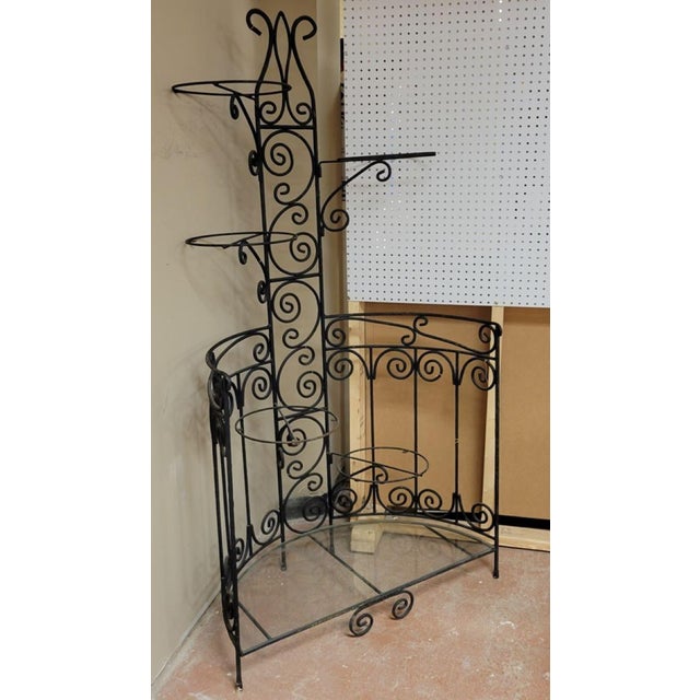 Wrought iron etagere or plant stand that works perfectly in a corner. The 5 arms swing to the right or left, so you can...
