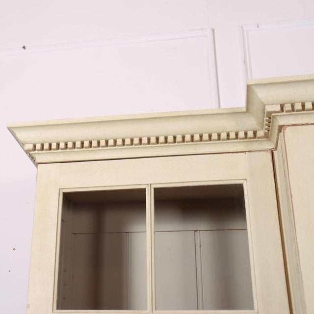 English breakfront pine bookcase. 1990 This piece is designed in the style of the selected designer and/or manufacturer