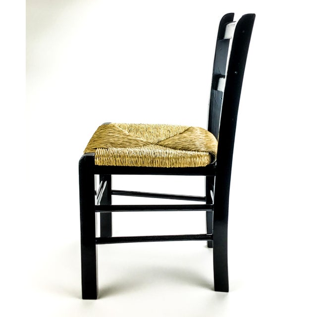 A great black lacquer side chair that is perfect for the kiddos. The wicker is in near perfect condition as shown. We...