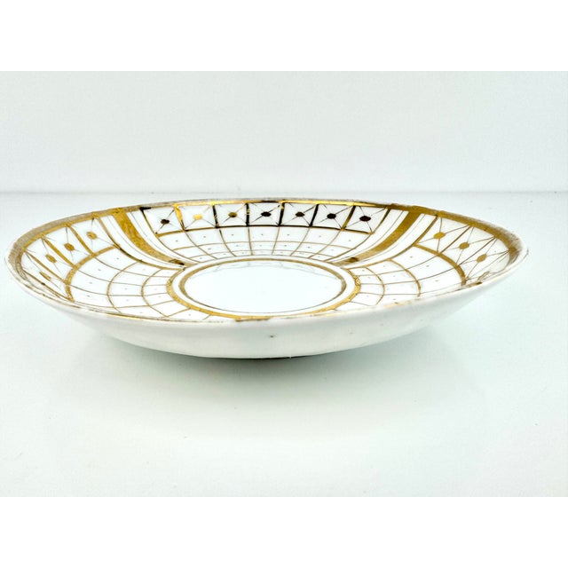 This vintage dish features a distinctive geometric design with elegant gold accents that evoke a sense of mid-century...