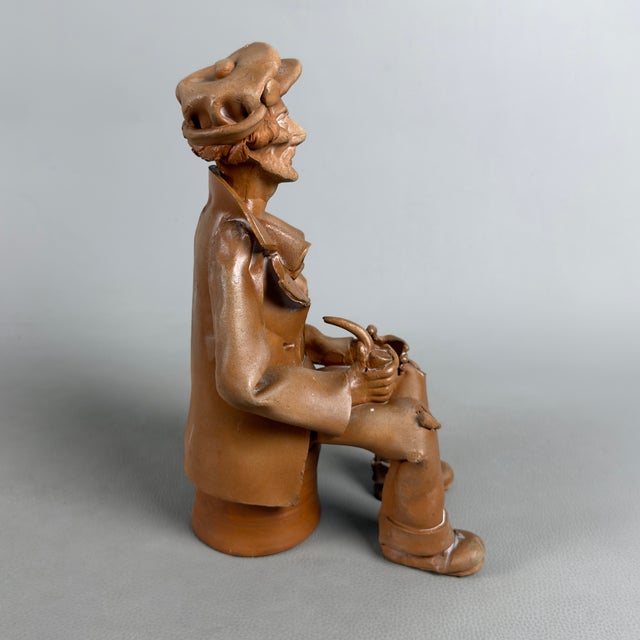 This sculpture captures the essence of Italian folk craftsmanship, reflecting the mastery of the figula tradition, likely...