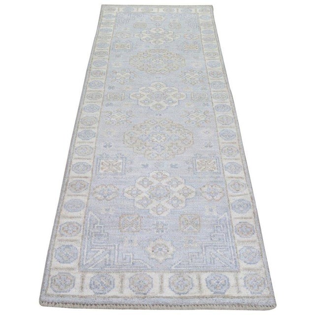 Hand-knotted with care using traditional rug-making techniques, this wool rug blends timeless craftsmanship with a modern...