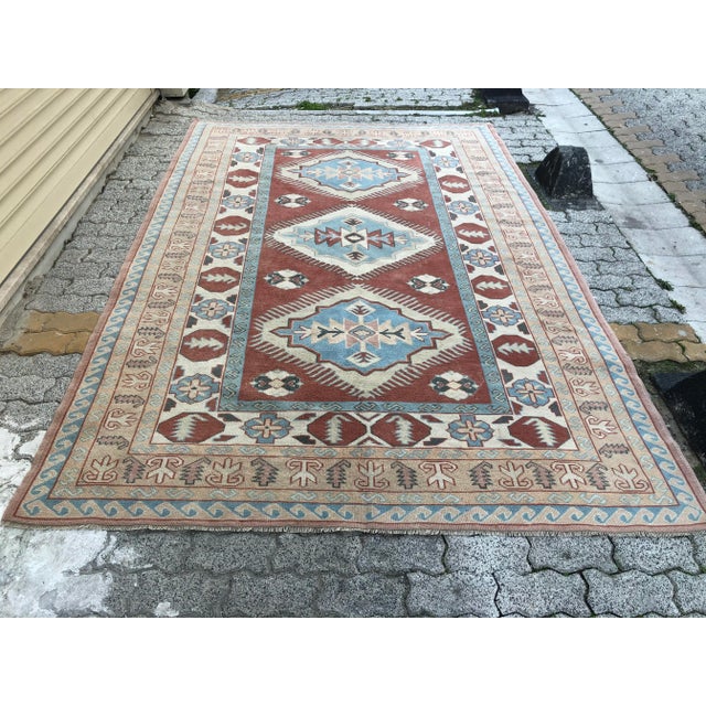 This is a vintage Turkish Oushak rug from the 1960s. The piece was hand-knotted.