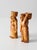 A charming pair of vintage Latin American folk art figures, depicting a man and woman carrying woven baskets atop their...