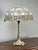 Inspired by the flowing lines and organic ornament of the Art Nouveau movement, this elegant two-light table lamp captures...