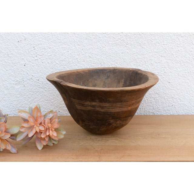 There is something deeply grounding about holding a vessel that was hewn by hand from a single block of wood. This antique...