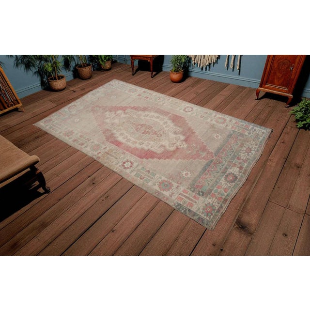 This is a beautiful vintage hand knotted distressed finish rug from Turkey. It has primary colors on green-cyanish gray...