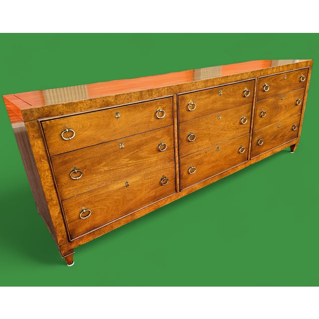 Featured is a Mid-Century Hollywood Regency Mastercraft Furniture 9-Drawer Long Dresser. Elevate your space with this...