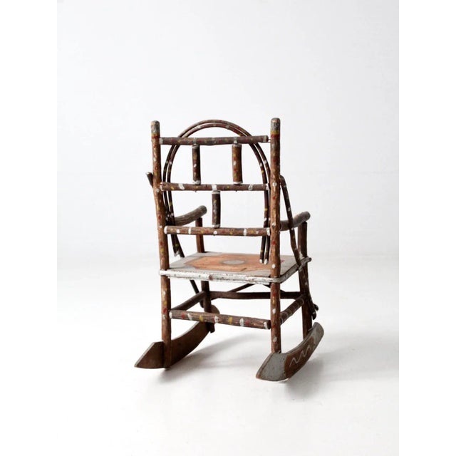 An antique Adirondack children’s rocking chair that exemplifies rustic folk art charm. Crafted from bentwood twigs, the...