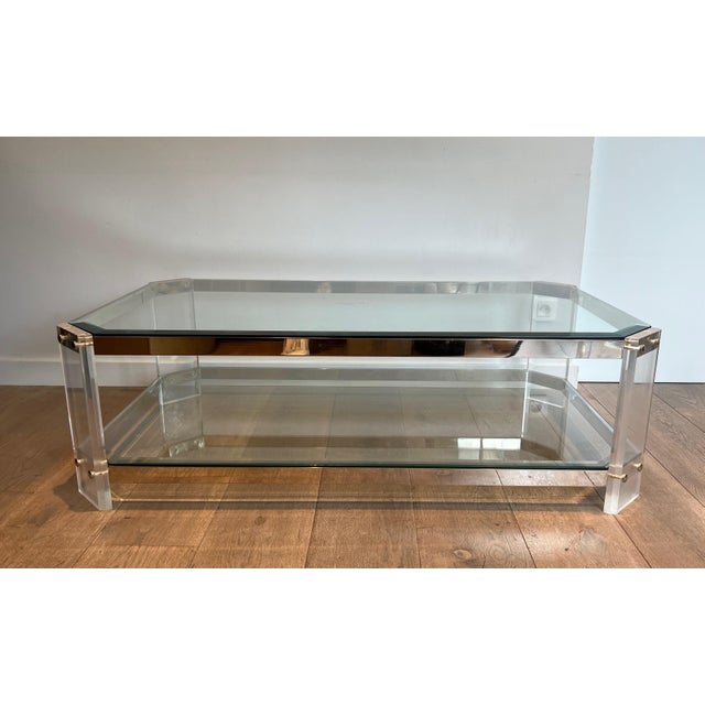 This beautiful decorative octagonal coffee table is made of lucite and chrome with four thick glass shelves. It is a...