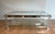 This beautiful decorative octagonal coffee table is made of lucite and chrome with four thick glass shelves. It is a...