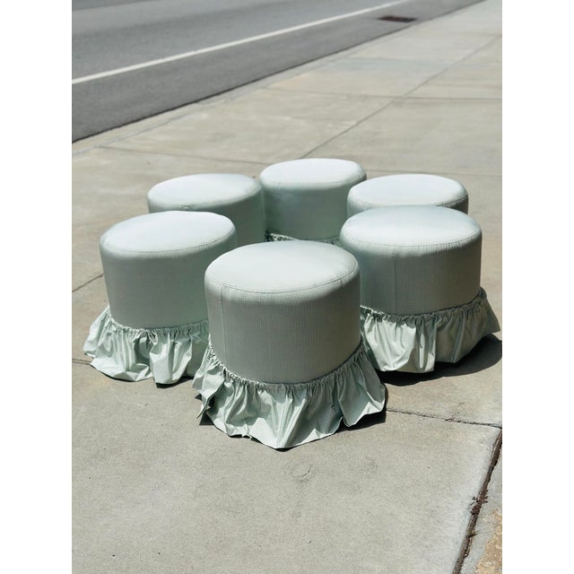 A charming set of six vintage round ottomans, newly upholstered in luxurious Scalamandré silk featuring a delicate pale...