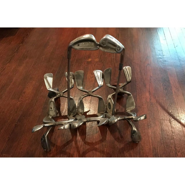 One of a kind functional art piece. These hand forged repurposed golf clubs make a wonderful magazine rack, fireplace wood...