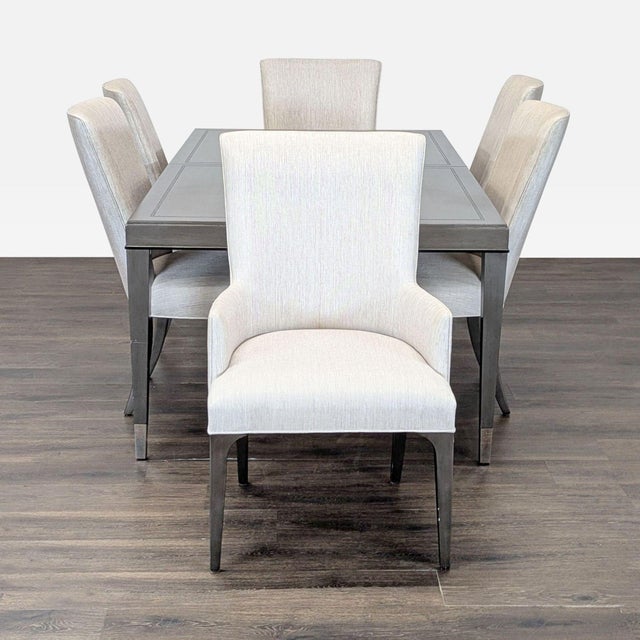 This Lexington dining set includes a sleek rectangular table and six comfortable upholstered chairs in a light neutral...