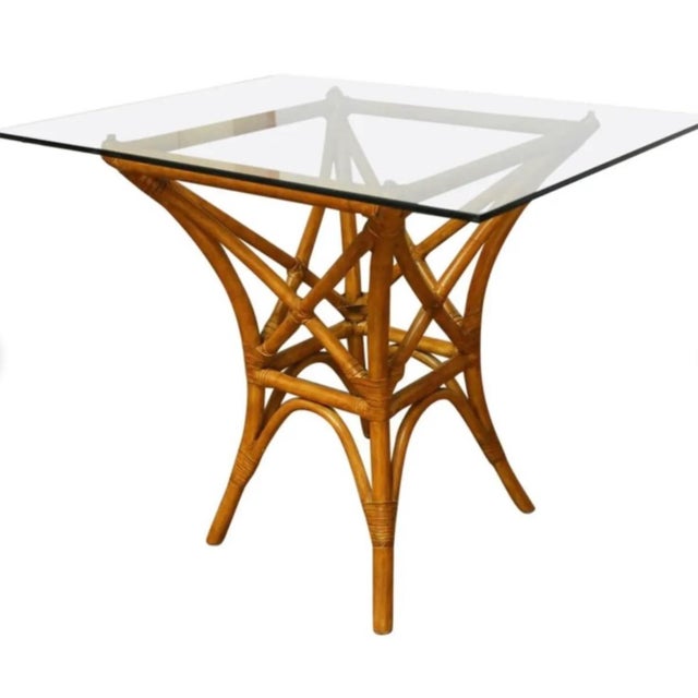 Organic modern rattan table for 4 chairs designed after McGuire. Elegant curves and leather laced joints assure quality...