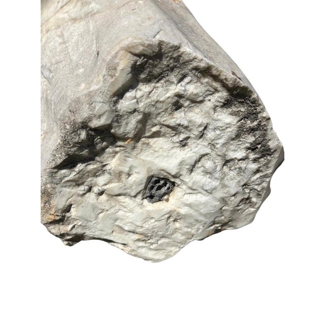 An imposing hand-carved sculpture of a classically inspired male bust in white carrara calacatta marble. The armless...