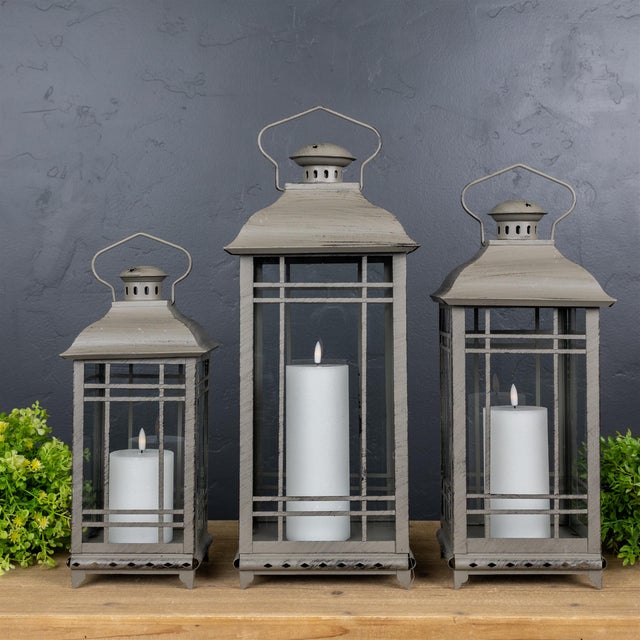 Elevate your home's ambiance with this stunning set of three traditional brown metal lanterns. Featuring a rustic,...