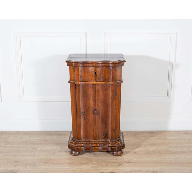 An exceptional Venetian bedside cabinet from the mid-18th century, crafted in solid walnut with a fir-wood interior...
