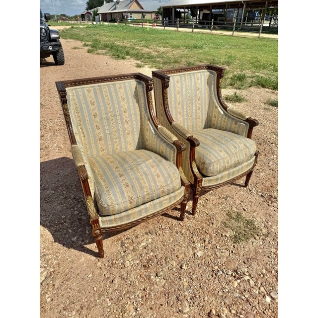 Large Pair of French Louis XVI Armchairs from France made of solid mahogany, the wood has been finished with a lustrous...