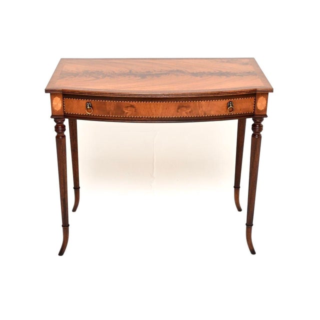 A beautiful and elegant antique inlaid writing / side table. This was made in England, it dates from around the 1920’s. It...