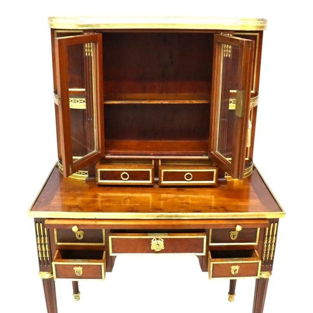 An exquisite antique Louis XVI style bonheur du jour (lady's desk), crafted from rich mahogany and adorned with elegant...