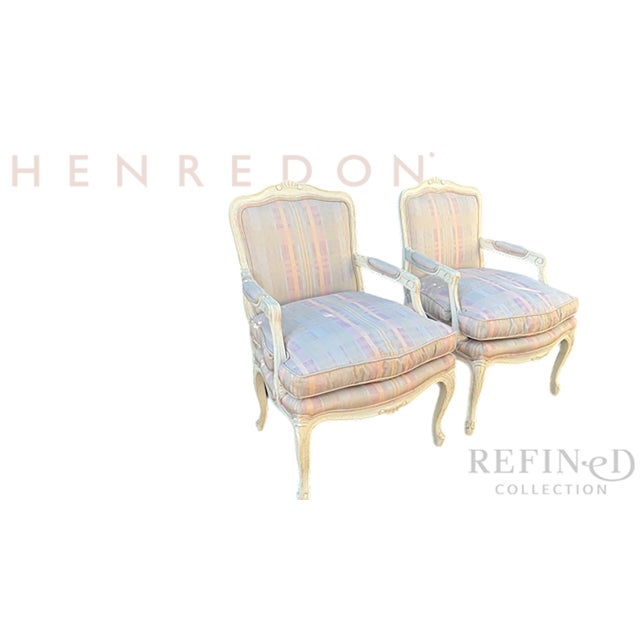 This refined pair of armchairs by Henredon is designed in the classic French fauteuil tradition, combining graceful...