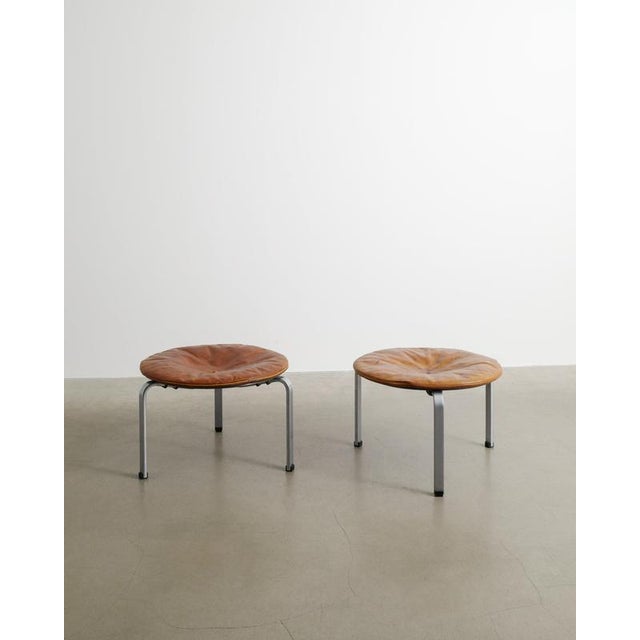 A rare and iconic pair of danish mid century modern "pk33" stools in b rushed chromium plated steel and original brown and...