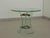 Glass coffee table with a brass frame and thick glass top, with three curved glass legs shaped by grinding. Produced by...