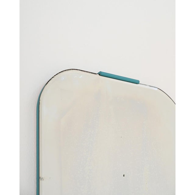 Wall mirror with a beveled edge and a thin turquoise lacquered wooden frame. Scandinavian design from the 1960s. This...
