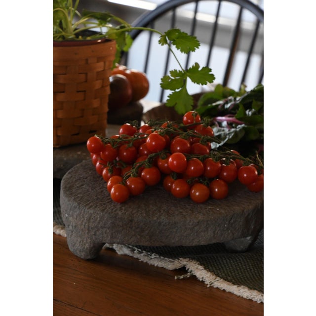 A 20th century riser carved from solid stone, resting on three small feet. Pieces like this were traditionally used in...