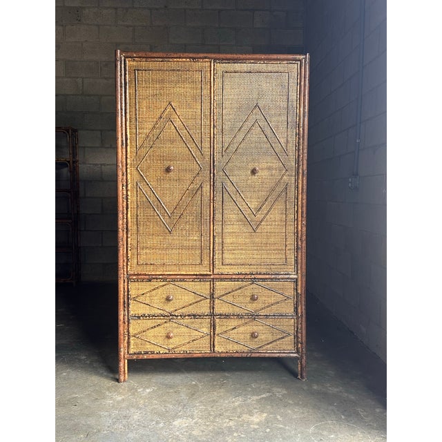 Vintage British colonial style dresser in bamboo and rattan. Two spacious drawers below doors leading to shelves, clad in...