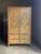Vintage British colonial style dresser in bamboo and rattan. Two spacious drawers below doors leading to shelves, clad in...