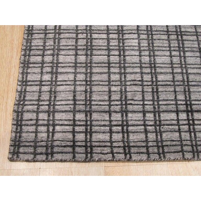 This gray contemporary rug is a hand knotted pile floor covering crafted from bamboo silk. Originating from India, the...