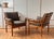 Original 60s/70s! Wonderfully simple Danish armchairs. The armchair is made of solid teak and brown seat cushions. The...