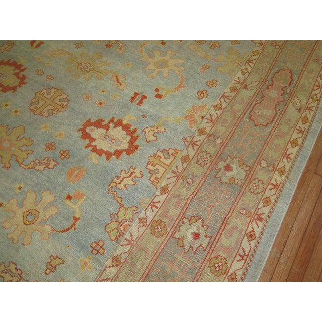 An early 20th century antique Turkish Oushak in predominant powder blue 9'8'' x 13'4'' Turkish Oushak rugs have become the...