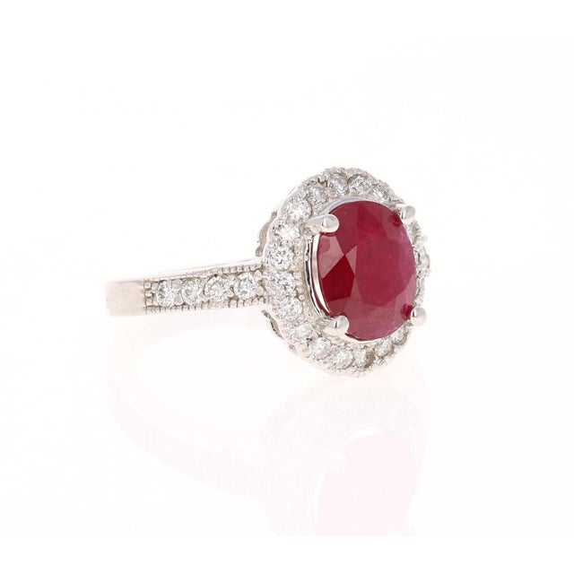 Stunning Ruby Diamond Ring with a natural 2.45 Carat Oval Cut Ruby and natural Round Cut Diamonds that weigh 0.54 carats....