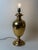 This monumental italian table lamp was crafted from exceptionally heavy solid brass during the 1970s. Its elegant urn-...