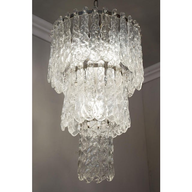 Elegant suspension chandelier with a circular metal structure, enriched by 55 plates in fine Murano glass arranged on...