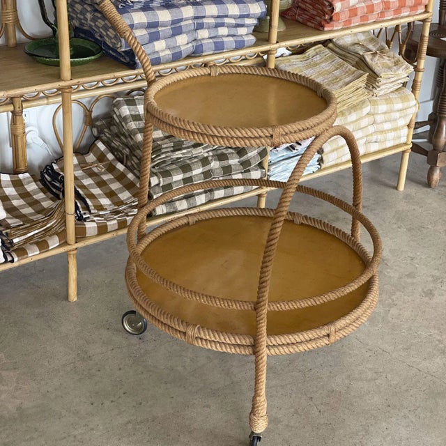 French 1960s rope bar cart by Adrien Audoux and Frida Minnet. Circular cart with two resin tiers, handle, and 4 original...