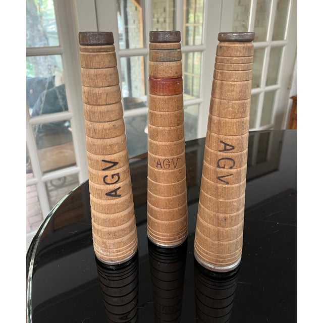 Hand turned tapered wood spools with metal reinforced ends. Originally created for factory use to hold yarns and threads....