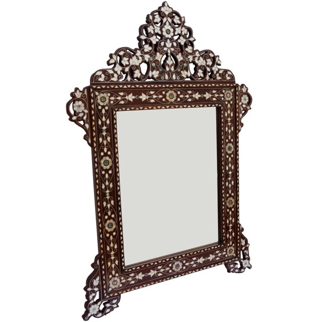 Exceptional vintage handcrafted Syrian mirror featuring an intricate hand-carved and reticulated solid walnut wood with...