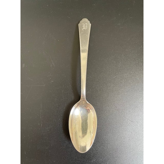 One (1) antique Lunt sterling 5⅞" teaspoon in the William & Mary pattern. Bears the early Rogers, Lunt & Bowlen Co. "RLB"...