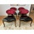 A stunning set of dining or side chairs by British luxury furniture designer Christopher Guy featuring red velvet oval...