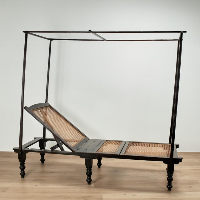 Rare and remarkable 19th century British colonial day bed handcrafted in mahogany with an adjustable, mechanical caned...